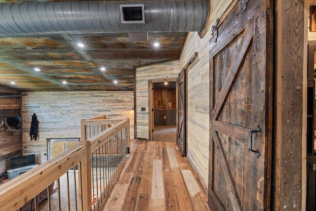 16688 248th St, Long Prairie, MN 56347 - hall featuring light wood-style flooring, wood walls, and visible vents