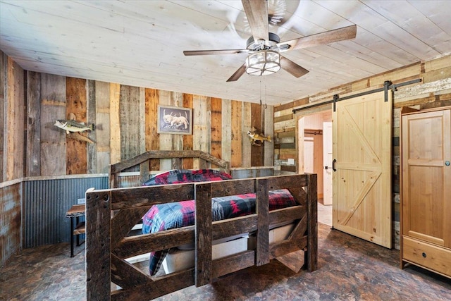 16688 248th St, Long Prairie, MN 56347 - bedroom featuring a barn door and wooden walls