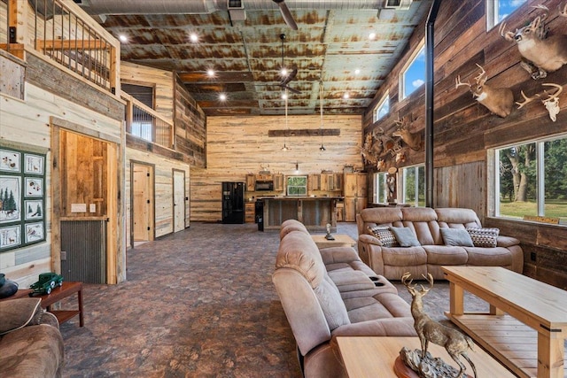16688 248th St, Long Prairie, MN 56347 - living area featuring wooden walls, a high ceiling, and carpet