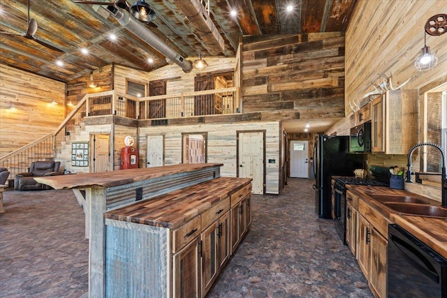 16688 248th St, Long Prairie, MN 56347 - kitchen featuring wooden counters, wood walls, and black appliances