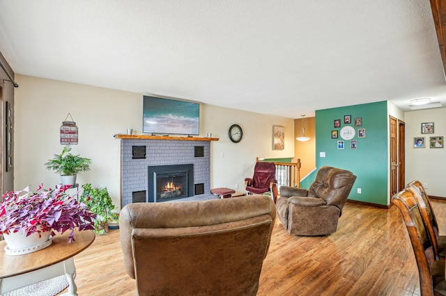 living area with a fireplace and light wood finished floors
