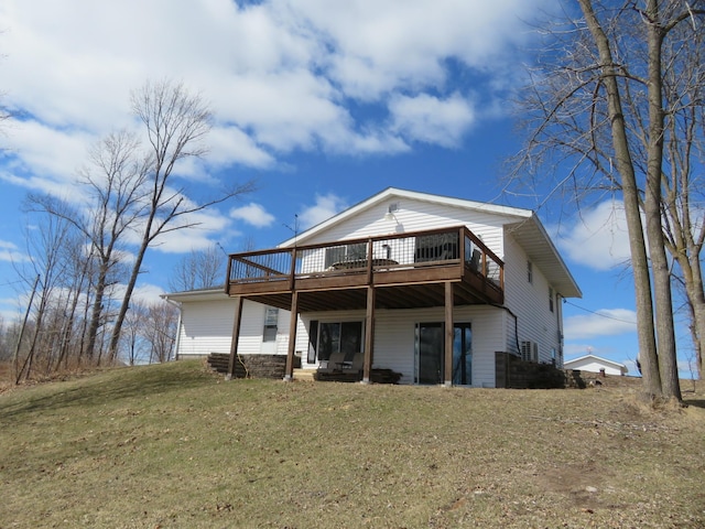 back of property featuring a yard and a wooden deck