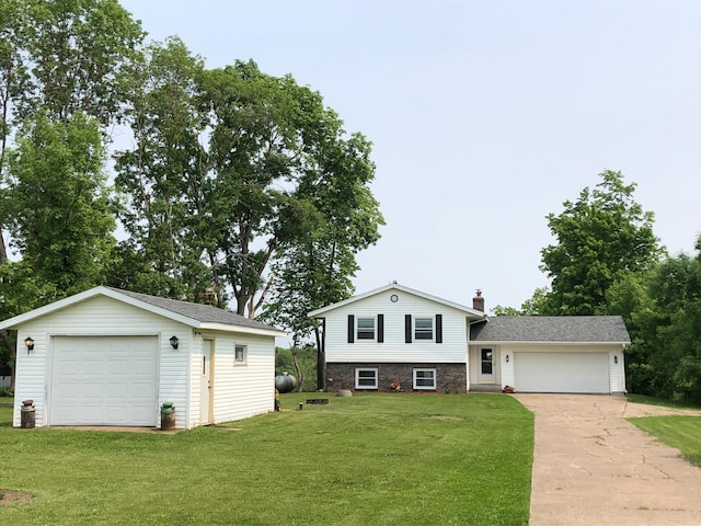 1794 White Ash Dr, Apple River Twp, WI 54810 - split level home featuring concrete driveway, a chimney, a front yard, and an outbuilding