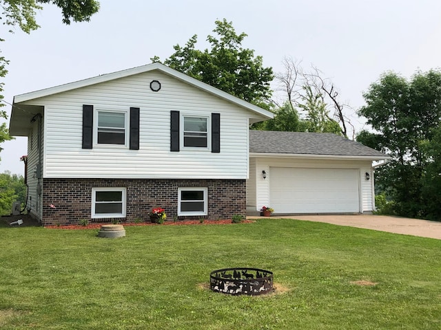 1794 White Ash Dr, Apple River Twp, WI 54810 - view of front of house with concrete driveway, an attached garage, a front yard, a fire pit, and brick siding
