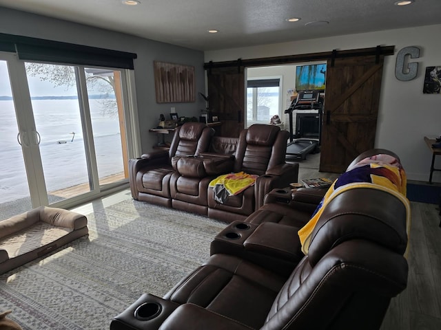living area with plenty of natural light, recessed lighting, and a barn door