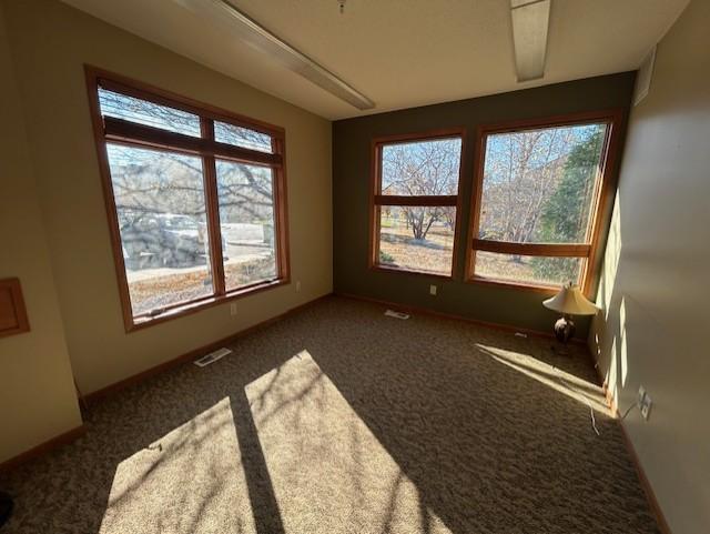 unfurnished sunroom featuring visible vents