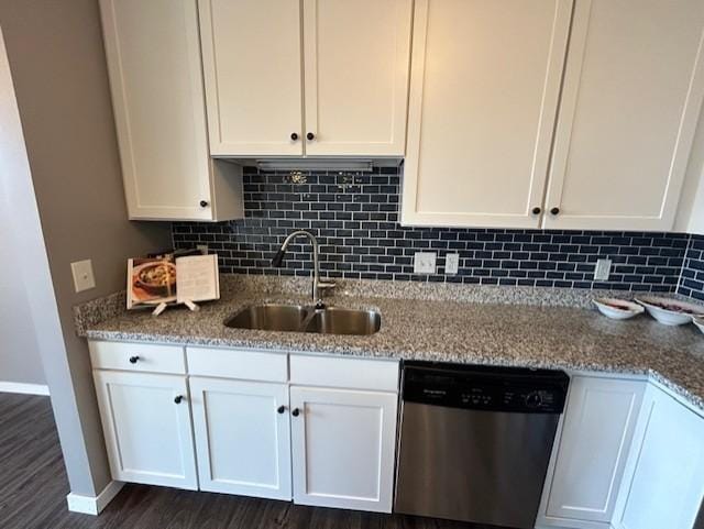 kitchen featuring a sink, stainless steel dishwasher, white cabinetry, and decorative backsplash