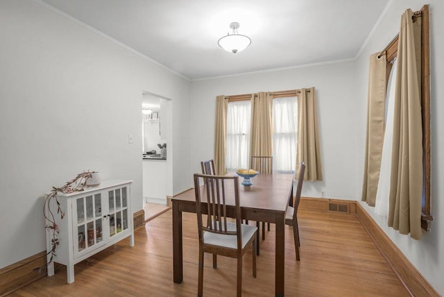 2136 Temple Ct, Saint Paul, MN 55104 - dining area with crown molding, light wood-style flooring, and baseboards