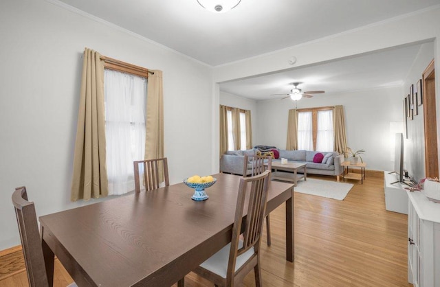 2136 Temple Ct, Saint Paul, MN 55104 - dining room featuring light wood-style floors, ornamental molding, and a ceiling fan