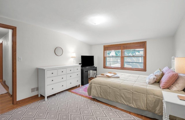 2136 Temple Ct, Saint Paul, MN 55104 - bedroom with light wood-style floors, vaulted ceiling, and baseboards
