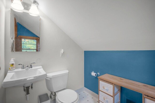 2136 Temple Ct, Saint Paul, MN 55104 - half bathroom with toilet, vaulted ceiling, tile patterned floors, and baseboards