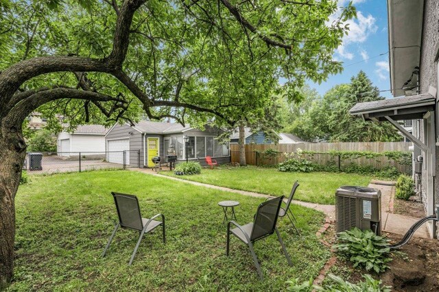 2136 Temple Ct, Saint Paul, MN 55104 - view of yard with central AC unit, an outbuilding, and an attached garage