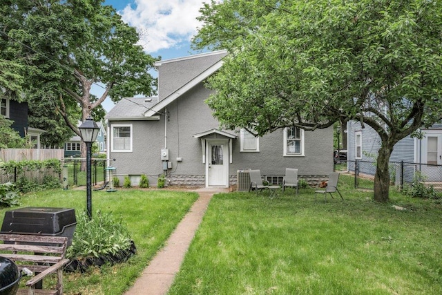 2136 Temple Ct, Saint Paul, MN 55104 - back of property featuring a garden, central AC unit, and stucco siding
