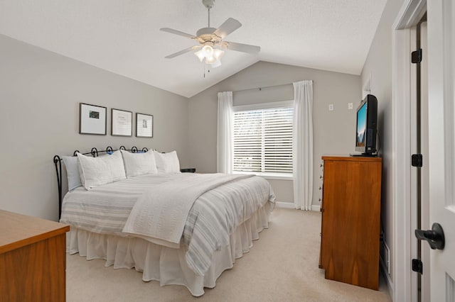 bedroom featuring baseboards, ceiling fan, lofted ceiling, and light colored carpet