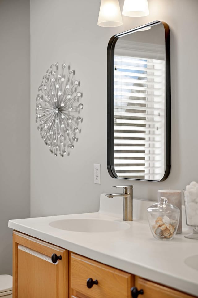 bathroom featuring a sink, toilet, and double vanity