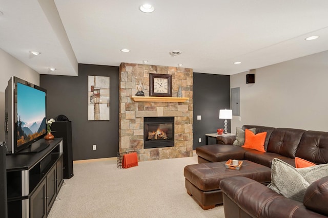 living room with recessed lighting, a stone fireplace, light carpet, and electric panel
