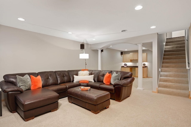living area featuring recessed lighting, decorative columns, stairs, and light carpet