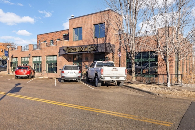 view of building exterior with uncovered parking