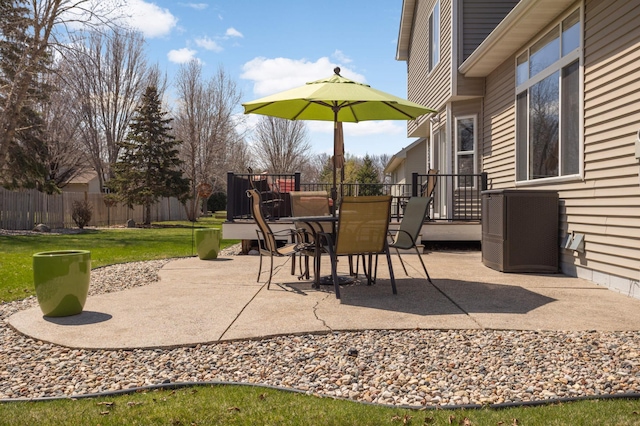 view of patio / terrace featuring fence, central AC unit, and outdoor dining space