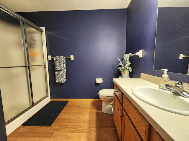 728 Elm St, Belle Plaine, MN 56011 - full bath with toilet, a stall shower, wood finished floors, and vanity