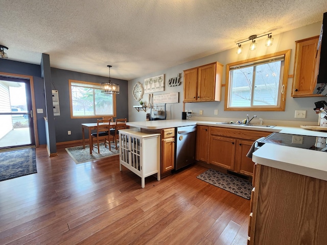 728 Elm St, Belle Plaine, MN 56011 - kitchen with a textured ceiling, dishwasher, a sink, and a peninsula