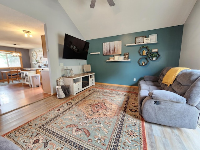 728 Elm St, Belle Plaine, MN 56011 - living area with wood finished floors, ceiling fan with notable chandelier, and vaulted ceiling