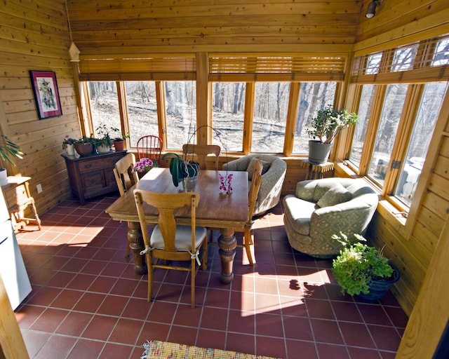 32990 Heilberger Dr, Erhard, MN 56534 - dining area with dark tile patterned flooring and wooden walls
