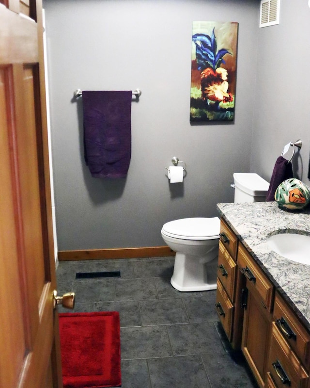 32990 Heilberger Dr, Erhard, MN 56534 - bathroom with vanity, toilet, baseboards, and tile patterned flooring