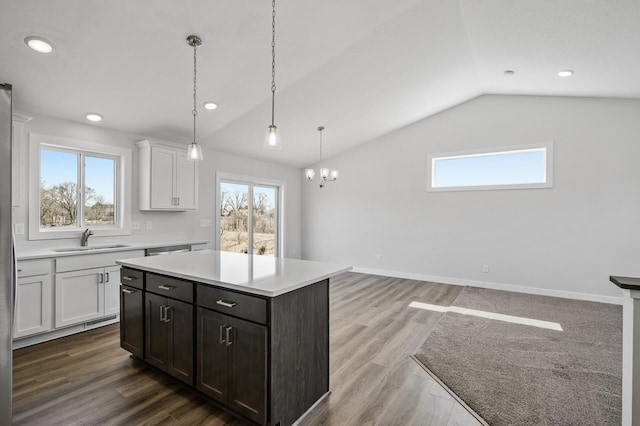 kitchen featuring white cabinets, plenty of natural light, light countertops, and a sink