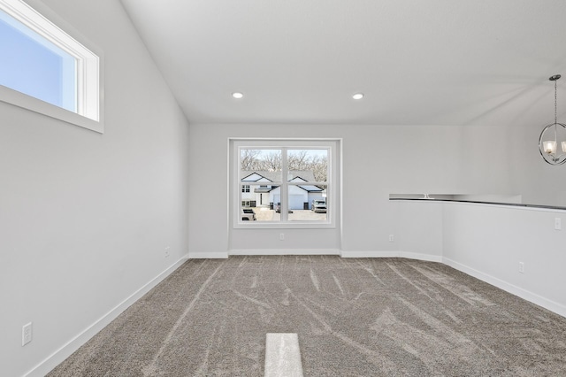 carpeted empty room with recessed lighting, baseboards, and an inviting chandelier