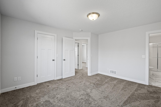 unfurnished bedroom featuring visible vents, baseboards, carpet flooring, and a textured ceiling