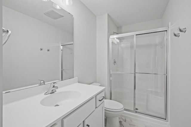 full bathroom featuring toilet, visible vents, a textured ceiling, and a stall shower