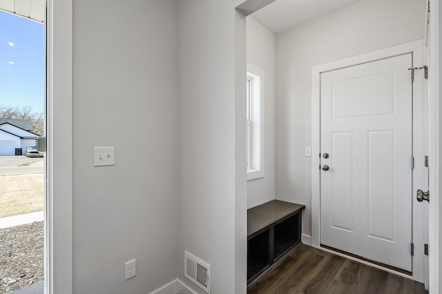 mudroom with dark wood-style flooring and visible vents
