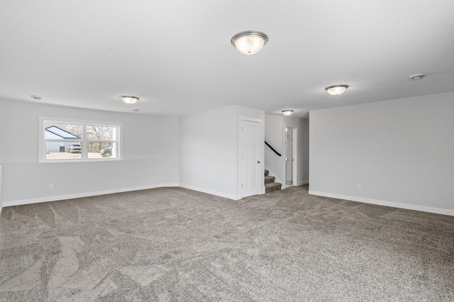 below grade area featuring stairway, carpet flooring, and baseboards