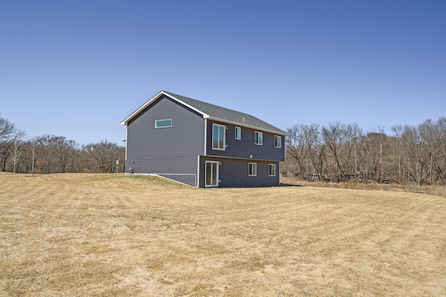 rear view of property with a lawn