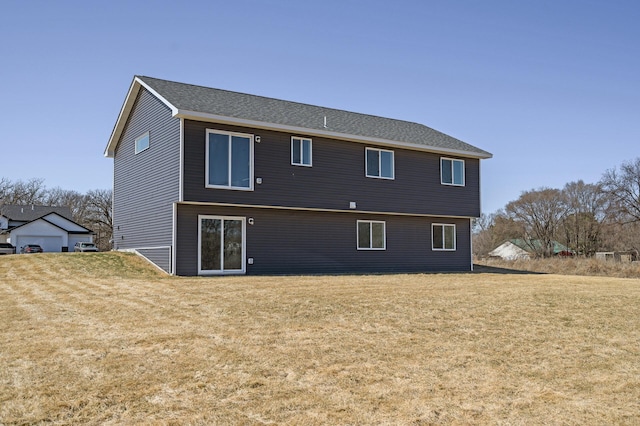 rear view of house featuring a lawn