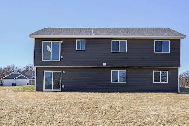 rear view of house with a yard