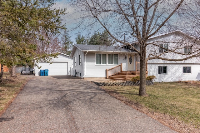103 8th St N, Sartell, MN 56377 - split level home with a shingled roof, a front lawn, an outbuilding, and a detached garage