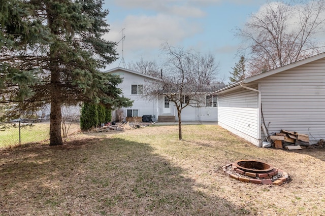 103 8th St N, Sartell, MN 56377 - view of yard featuring fence, entry steps, and an outdoor fire pit