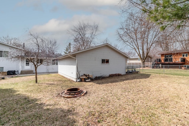 103 8th St N, Sartell, MN 56377 - view of side of property with a lawn, a fenced backyard, and an outdoor fire pit