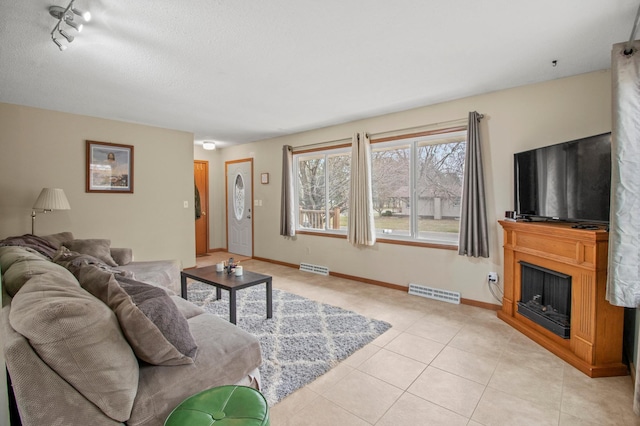 103 8th St N, Sartell, MN 56377 - living room with baseboards, visible vents, rail lighting, and light tile patterned flooring