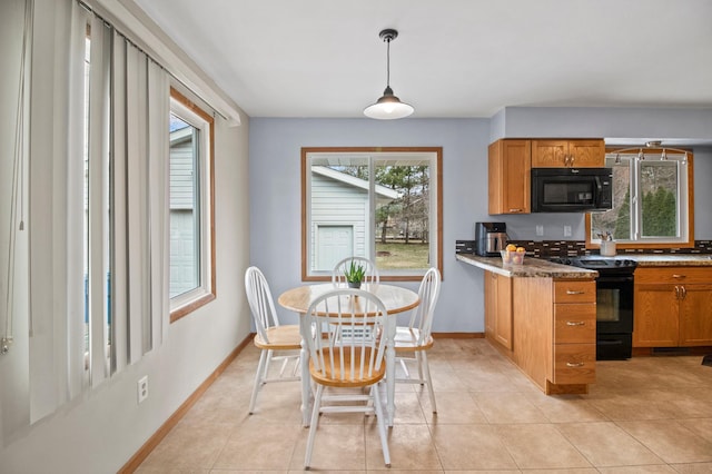 103 8th St N, Sartell, MN 56377 - kitchen with brown cabinetry, baseboards, and black appliances
