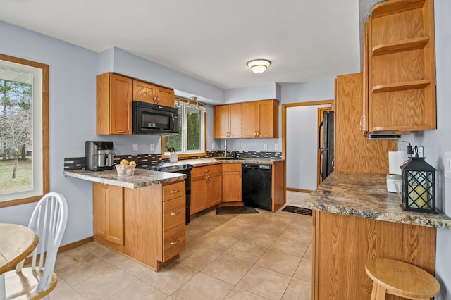 103 8th St N, Sartell, MN 56377 - kitchen with a peninsula, a kitchen breakfast bar, a sink, open shelves, and black appliances