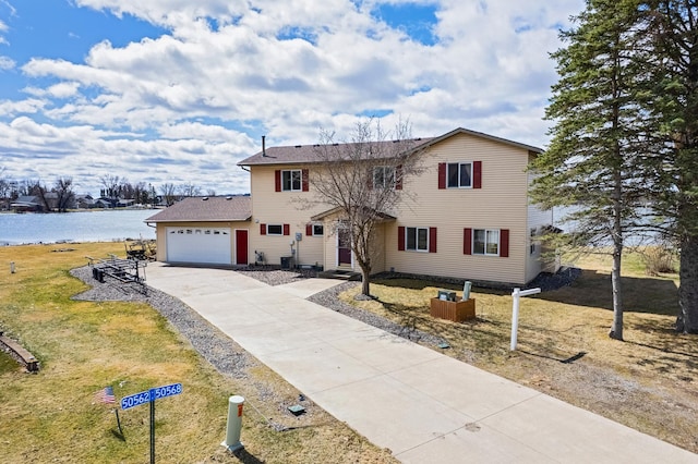 50568 Lakeside Cir, Rush City, MN 55069 - traditional-style house with driveway, a garage, a water view, a front yard, and roof with shingles