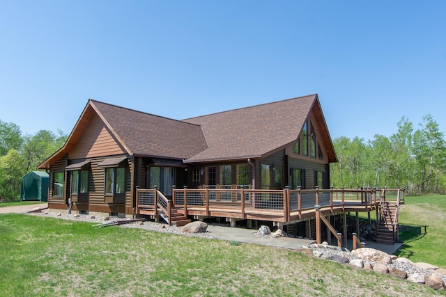 24341 Bluebird Ave, Trommald, MN 56441 - view of front of house with a wooden deck, log exterior, a front yard, and roof with shingles