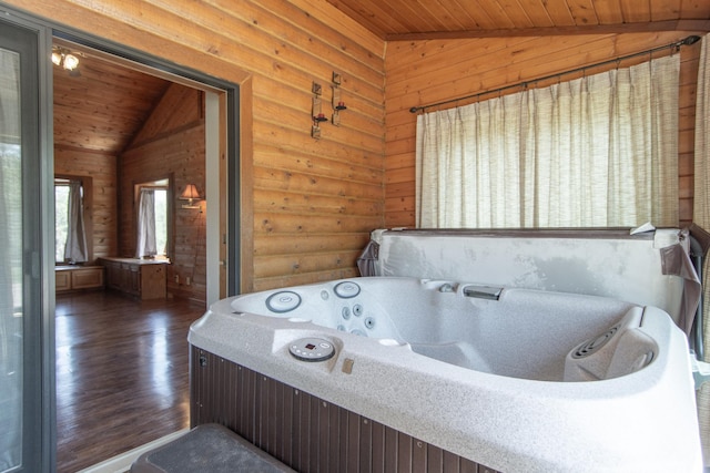 24341 Bluebird Ave, Trommald, MN 56441 - bathroom featuring lofted ceiling, wood ceiling, wood finished floors, a whirlpool tub, and rustic walls