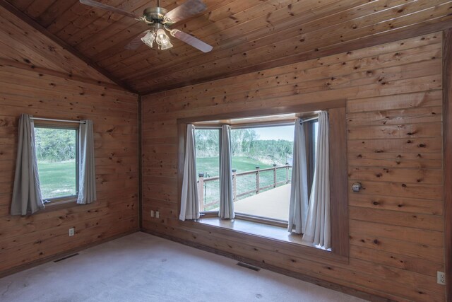 24341 Bluebird Ave, Trommald, MN 56441 - carpeted empty room featuring wooden walls, a ceiling fan, wood ceiling, and vaulted ceiling