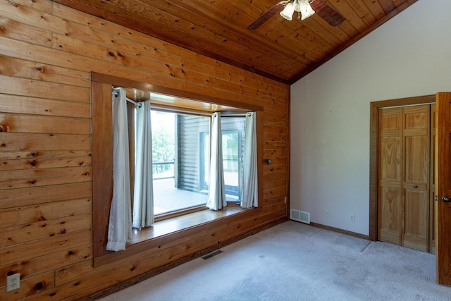 24341 Bluebird Ave, Trommald, MN 56441 - empty room featuring vaulted ceiling, a ceiling fan, light colored carpet, wooden ceiling, and wood walls