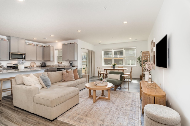 living room with recessed lighting and light wood finished floors