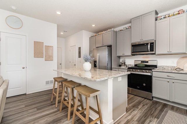 kitchen with gray cabinetry, appliances with stainless steel finishes, and dark wood-type flooring